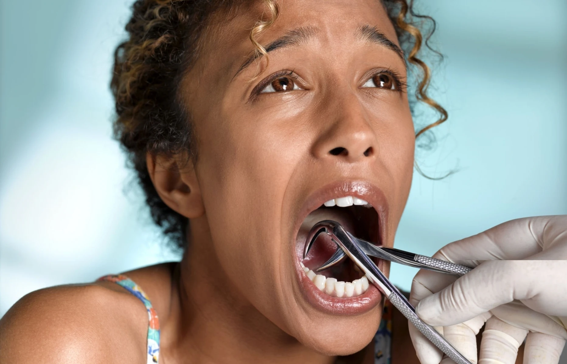 woman opening her mouth for teeth removal